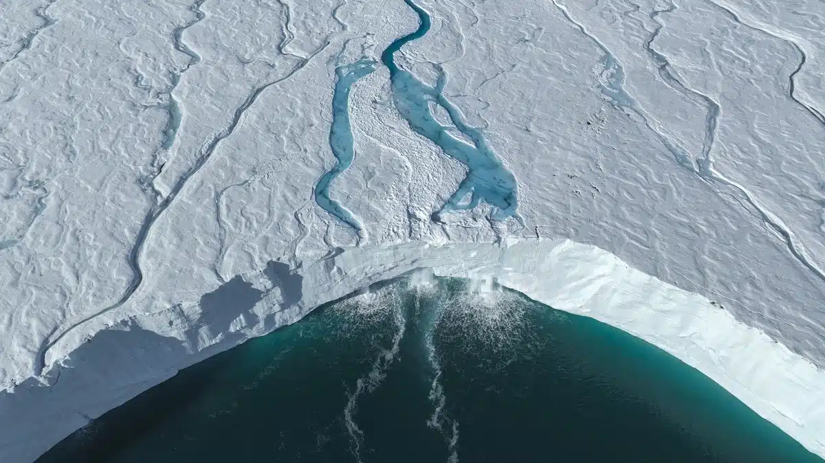 A melting ice shelf in the Arctic creates numerous waterfalls.