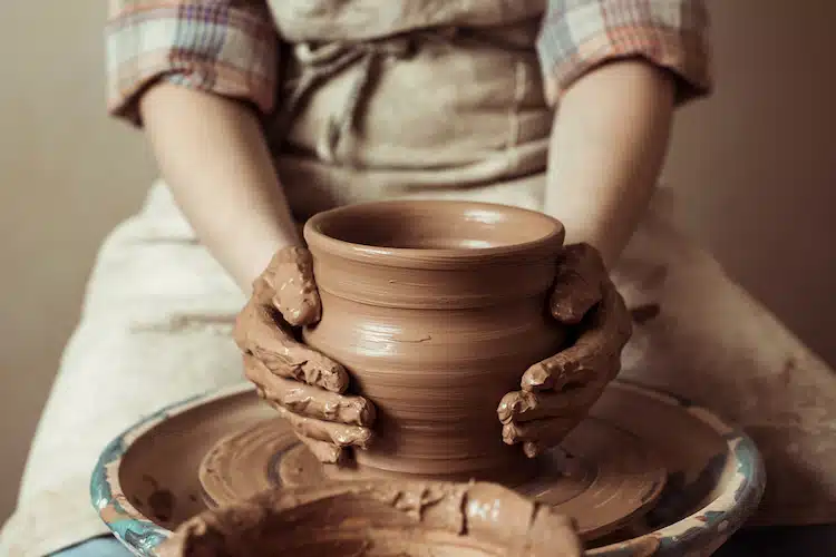 Close up of hands making pottery