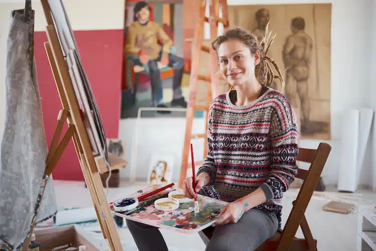 Smiling woman painting