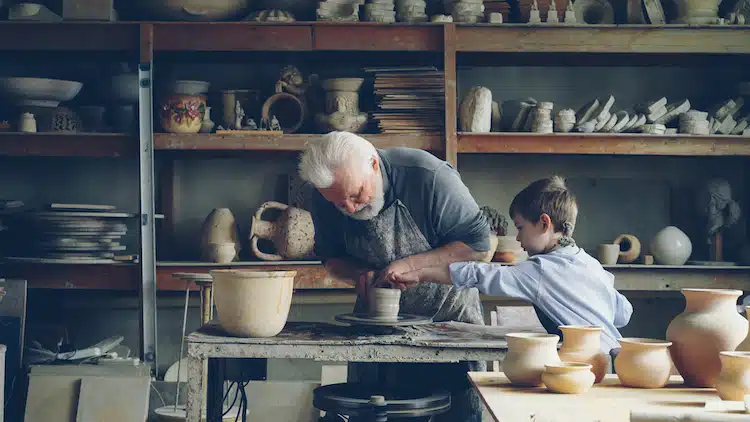 Old man and child making pottery